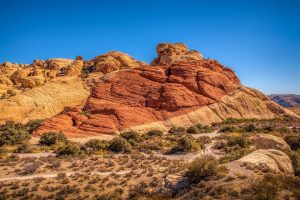 Majestic red rock formations under a bright blue sky.