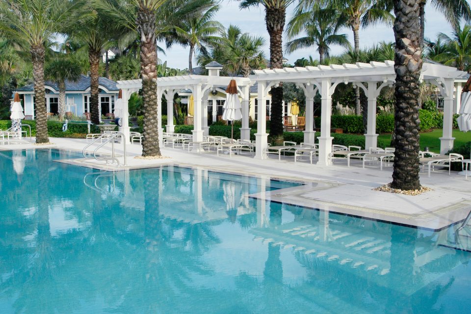 Beautiful cabanas around a pool.