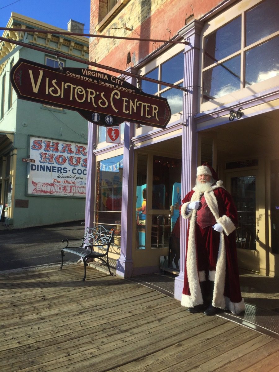 Santa Claus standing in front of a Virginia City sign.