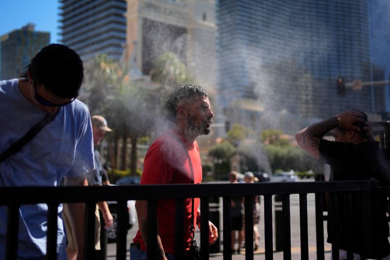 People cool off in misters along the Las Vegas Strip, Sunday, July 7, 2024, in Las Vegas