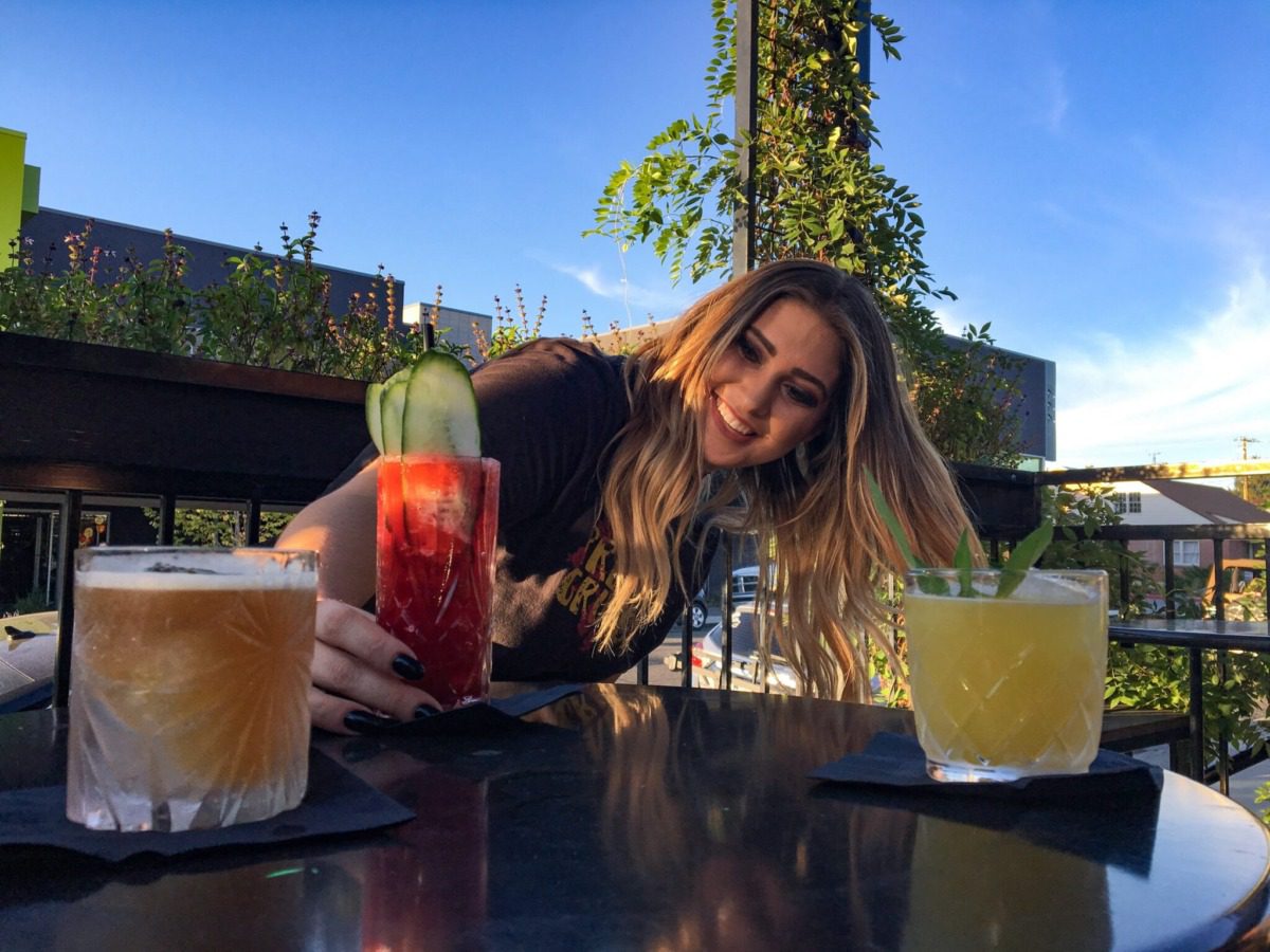 a woman surrounded by colorful drinks